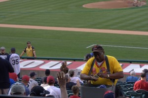 Peanut vendor (with a booming loud voice)