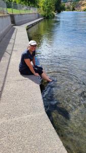 Marion dangles her toes in the Deschutes River in Maupin