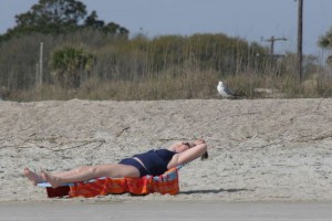 Sunbather and sea gull